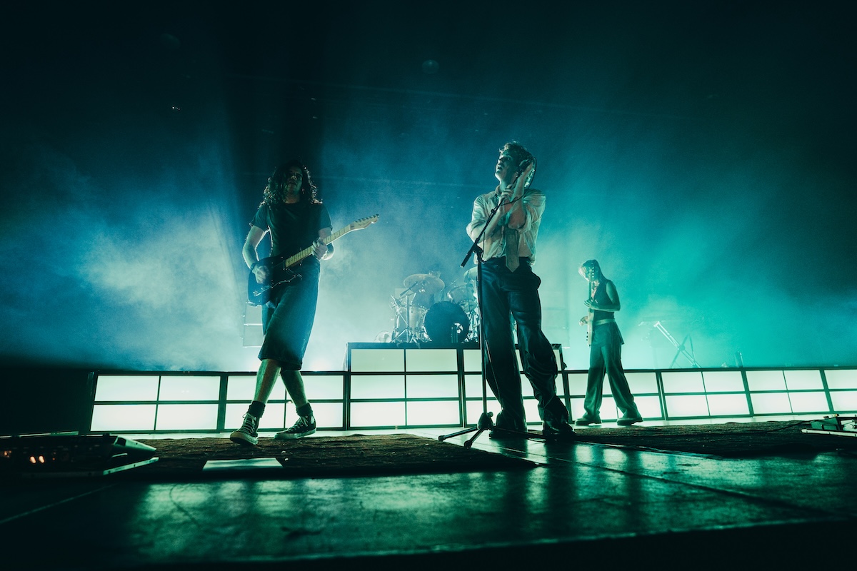 Spacey Jane performing live onstage under teal blue backlighting with smoke, captured in concert photography by Charlie Hardy.